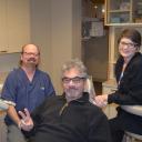Happy root canal patient with Dr. Hickey and dental hygienist at Sound to M