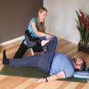 Moriah helps Karl post-bunion surgery using yoga therapy at Yoga Mojo &