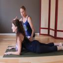 Moriah teaches yoga and pranayama or breathing exercises to Kelly at Yoga M
