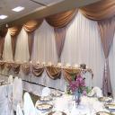 Traditional curtains, silk chair dressings, and fine dining ware were exact