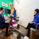 Dr. Ciano of Montgomery Pediatric Dentistry explains a dental procedure to 